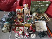 Overall view of lot showing tree topper, ornament boxes, figurines, lights, tin and accessories
