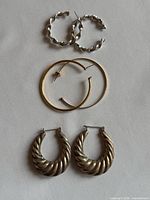 All three earring pairs laid out vertically