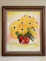 Full view of framed painting showing yellow flowers in red vase