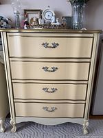 Front view showing full dresser, drawers, hardware, legs