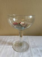 Full view of clear goblet holding matchbooks