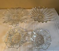 Top view of four clear glass serving pieces