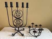 Both wrought iron candelabras side by side