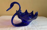 Full profile of cobalt blue art glass swan bowl showing neck, body and ruffled rim