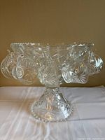 punch bowl on pedestal with cups hanging from rim