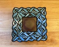 Top view showing blue stained glass mosaic pattern and central candle recess