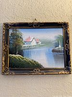 Full view of framed landscape painting on wall