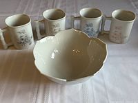 Overall lot showing four floral mugs and white lotus bowl