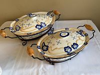 Two oval casserole dishes in metal racks showing full set