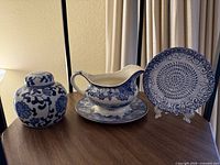 Overall lot showing gravy boat on underplate, spiral plate on stand, ginger jar
