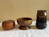 Group shot of all three items—woven apple basket, wooden pedestal bowl, stoneware cup