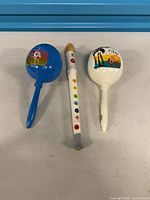 Front view of blue maraca, Janod recorder, white Los Cabos maraca