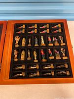 Interior view showing full set of themed resin chess pieces in flocked tray