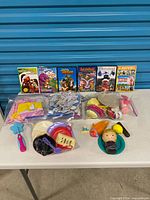 Full lot view showing DVDs, puzzle bags, toy kitchen items and figures