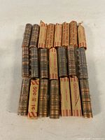 Stacked paper-wrapped and plastic-wrapped Canadian penny rolls