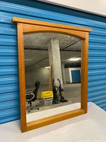 Front view of mirror showing wood frame and glass
