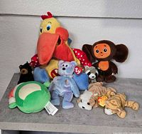 Group shot of all seven plush toys on shelf