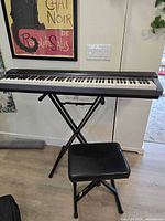 Full view of keyboard on stand with bench