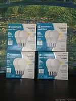 Front view of four sealed Ecosmart smart bulb two-packs showing specifications