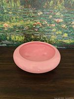 Top view of pink ceramic shallow bowl showing interior glaze and rounded rim