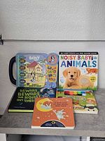 All six board books grouped on shelf, front covers visible