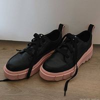 Pair of black Sorel sneakers with pink sole