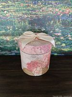 Hat box exterior showing floral design and ribboned lid