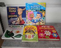 Front view of five books: Llama Llama Red Pajama, Bubble Guppies, Where Is The Very Hungry Caterpillar?, Easter Bunny, Pop-Up Peekaboo! Numbers