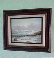 Framed seascape painting hung on wall