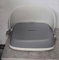 Front view of OXO Tot Perch booster seat folded open