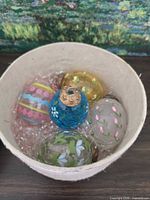 Five glass egg ornaments in paper box