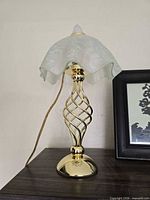 Front view of brass table lamp, shade removed showing details