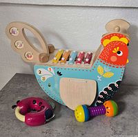 Overall view of wooden chicken xylophone toy and ladybug rattle