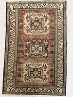 Full view of rectangular Caucasian rug showing overall design and proportions