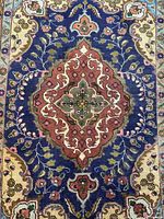 Close-up of central medallion highlighting colors and knotting detail