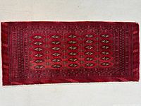 Full view of red Turkman wool mat showing overall design and size