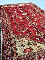 Angled close-up of rug displaying pile texture and colours