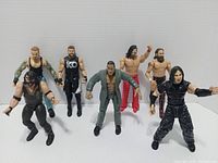 Full group of seven WWE figures standing