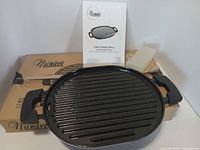 Oval cast iron grill pan, drip tray, manual and original box visible