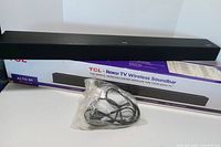 Soundbar on top of original Alto R1 box with bagged power cord