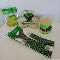 all four items grouped: ceramic hat planter, suspenders, foam shamrocks pack, wooden sign