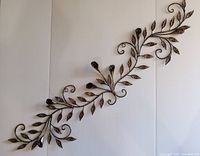 Full view of metal vine and leaf wall sculpture
