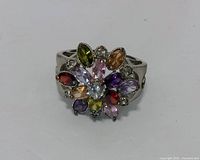 Front view of sterling silver ring showcasing multicolored gemstone flower cluster design