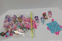 Bag containing numerous baby unicorn figures and accessories