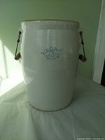 Front view of cream stoneware crock showing blue crown 3 mark and bail handles