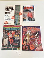 Front covers of four Clemson football related print items arranged on surface
