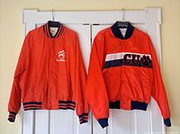 Both bomber jackets hanging to show overall appearance, color and logos