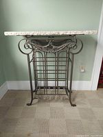Full front view showing marble top and wrought iron wine rack frame