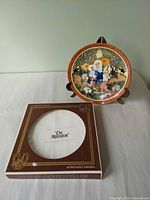 Plate on stand with box beside it