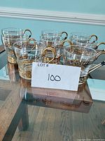 All eight cups grouped on glass table